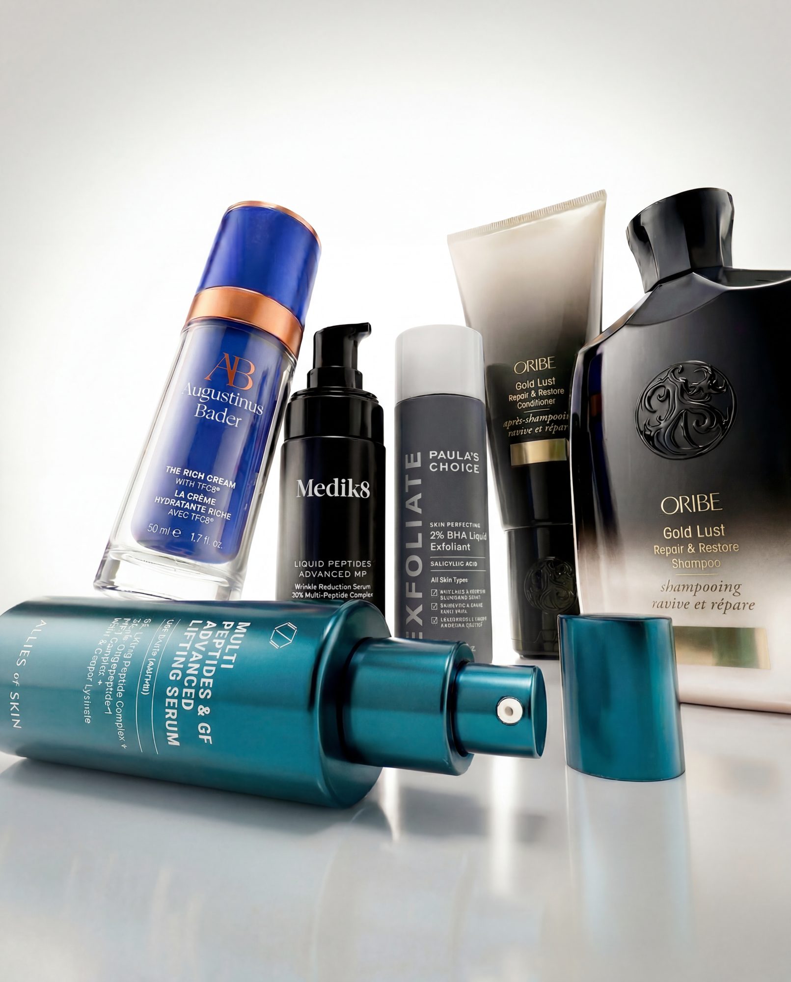 Skincare and haircare bottles in a studio still life