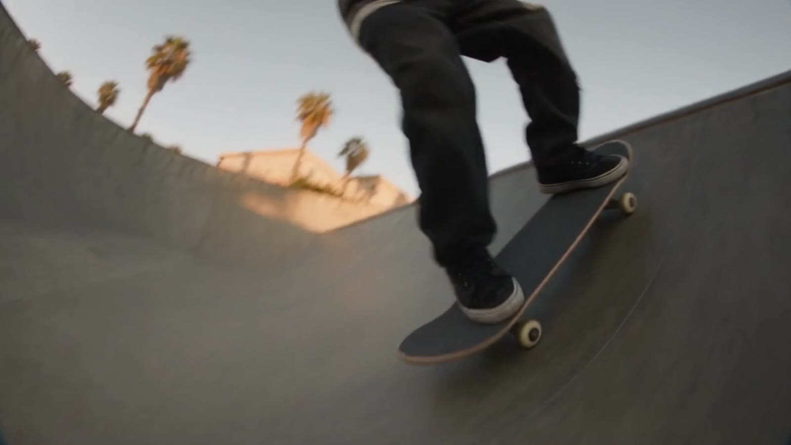 Skater riding a bowl at golden hour